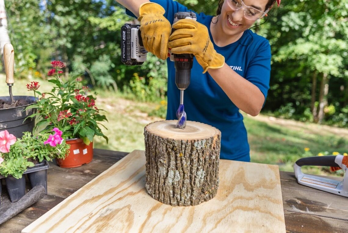 Using power tool to drill into center of lumber